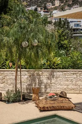 a pillow sitting on the ground next to a wall at Casa Meraki by A&D Properties in Porto Rafti