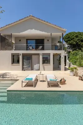 a villa with a swimming pool next to a house at Casa Meraki by A&D Properties in Porto Rafti