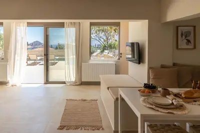 a kitchen and living room with a view of a patio at Casa Meraki by A&D Properties in Porto Rafti