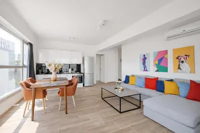 a living room with a couch and a table at Costa Alimos by Verde Apartments in Athens