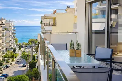 a balcony with a table and a view of the ocean at Costa Alimos by Verde Apartments in Athens