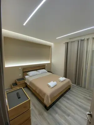 a bedroom with a bed with two towels on it at Modern Rous Apartment in Athens in Athens