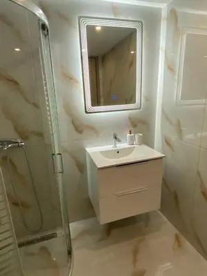 a bathroom with a sink and a shower and a mirror at Modern Rous Apartment in Athens in Athens