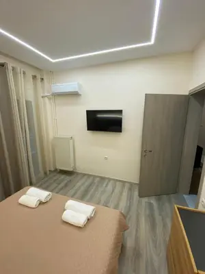 a room with a bed with two towels on it at Modern Rous Apartment in Athens in Athens