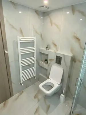 a bathroom with a white toilet in a room at Modern Rous Apartment in Athens in Athens
