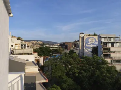 a view of a city with a sign on the side of a building at Acropolis View top floor apartment in Athens