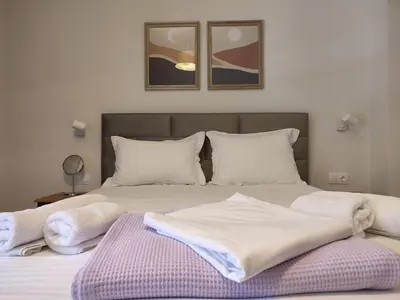 a bed with white blankets and pillows on it at Acropolis Oasis by YHA in Athens