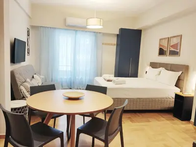 a room with a bed and a table and chairs at Acropolis Oasis by YHA in Athens