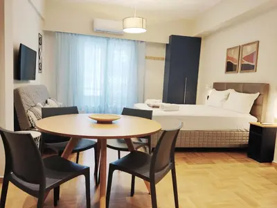 a room with a table and chairs and a bed at Acropolis Oasis by YHA in Athens