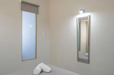 a bathroom with a mirror and a towel at Divine 2BR Apartment in the Heart of Athens in Athens