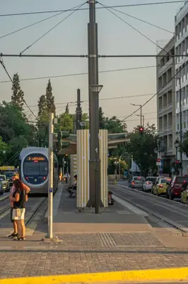 a group of people waiting for a bus at a train station at Divine 2BR Apartment in the Heart of Athens in Athens