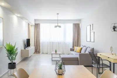 a living room with a couch and a table at Divine 2BR Apartment in the Heart of Athens in Athens