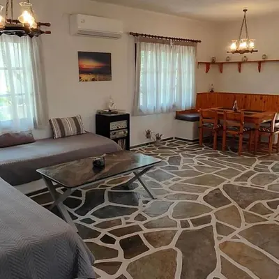 a living room with a couch and a table at Sylvia's house at Vagia in Vaia