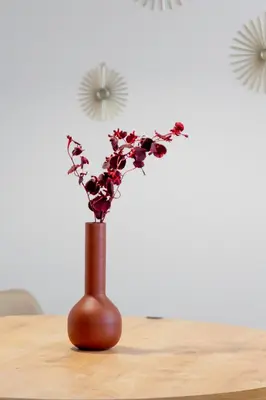 a brown vase with flowers in it on a table at Harmony 2BR Apartment in Athens in Athens