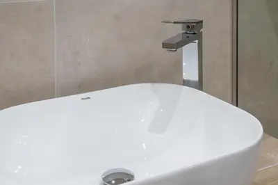 a white sink in a bathroom with a faucet at Harmony 2BR Apartment in Athens in Athens