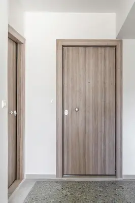 a pair of wooden doors in a room at Harmony 2BR Apartment in Athens in Athens