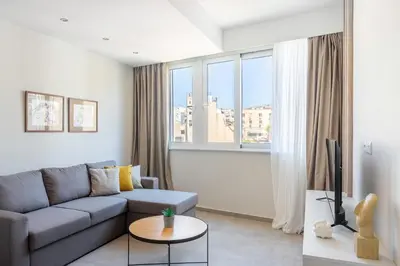 a living room with a couch and a large window at Harmony 2BR Apartment in Athens in Athens