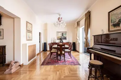 a dining room with a table and a piano at All time Classic: Pianist's 5th FL Apt @ Acropolis in Athens