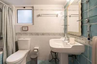 a bathroom with a white toilet and a sink at All time Classic: Pianist's 5th FL Apt @ Acropolis in Athens