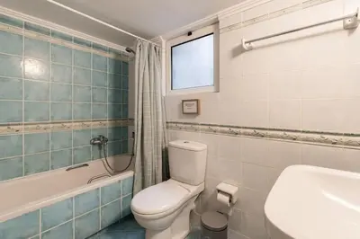 a bathroom with a toilet and a tub and a sink at All time Classic: Pianist's 5th FL Apt @ Acropolis in Athens