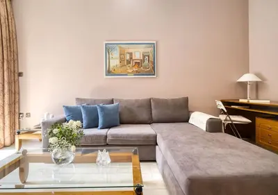 a living room with a couch and a coffee table at Μοντέρνο διαμέρισμα 2' από το μετρό in Athens