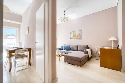 a living room with a couch and a table at Μοντέρνο διαμέρισμα 2' από το μετρό in Athens