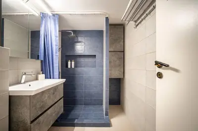a bathroom with a sink and a shower at Μοντέρνο διαμέρισμα 2' από το μετρό in Athens