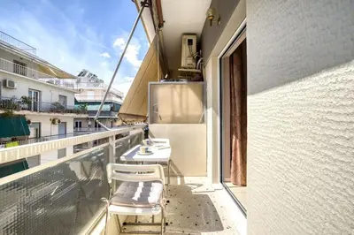 a balcony with lounge chairs on a building at Μοντέρνο διαμέρισμα 2' από το μετρό in Athens