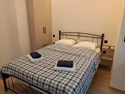 a bedroom with a bed with two towels on it at Apartment Dipla in Athens