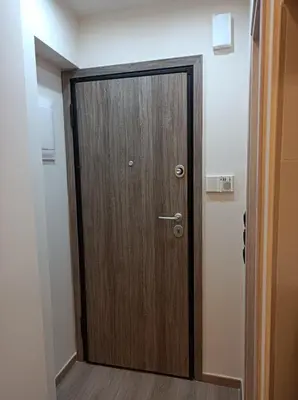 a wooden door in a room with a hallway at Apartment Dipla in Athens