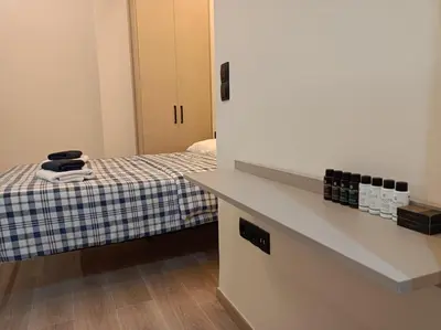 a small room with a bed and a counter at Apartment Dipla in Athens