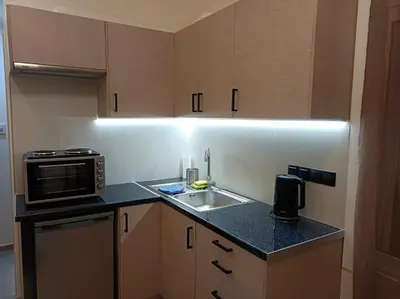 a kitchen with a sink and a microwave at Apartment Dipla in Athens