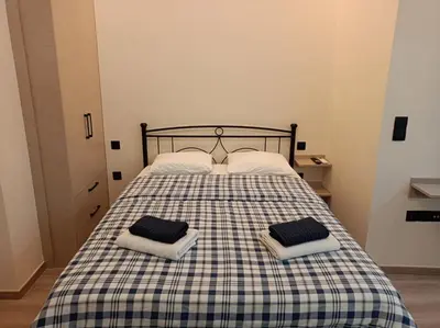 a bedroom with a bed with two pillows on it at Apartment Dipla in Athens