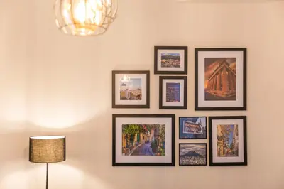 a group of framed pictures on a wall at Sweet greek memories-Acropolis in Athens
