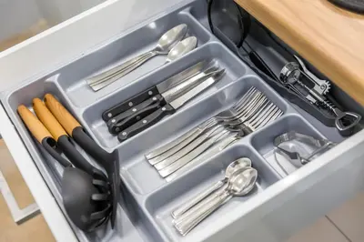 a plastic container filled with utensils in a drawer at Sweet greek memories-Acropolis in Athens