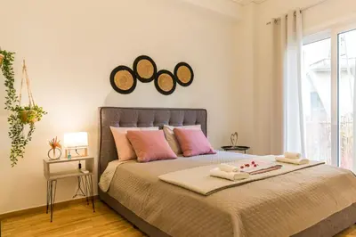 a bedroom with a bed with two mirrors on the wall at Sweet greek memories-Acropolis in Athens