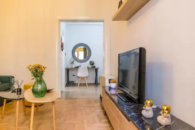 a living room with a flat screen tv and a table at Sweet greek memories-Acropolis in Athens