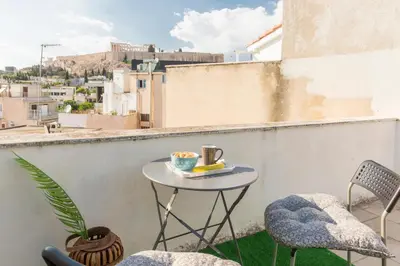 a small table on a balcony with a cup of coffee at Sweet greek memories-Acropolis in Athens