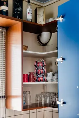 a pantry door open to a kitchen with dishes at Pantheon Penthouse, Athens Riviera in Athens