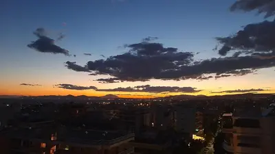 a view of a city at sunset at Pantheon Penthouse, Athens Riviera in Athens