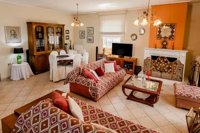 a living room with two couches and a fireplace at Pantheon Penthouse, Athens Riviera in Athens