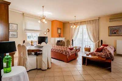 a living room with a couch and a table at Pantheon Penthouse, Athens Riviera in Athens