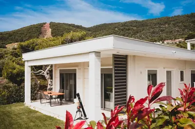 a white house with a table and a mountain at Greek Sea Villas Kaki Thalassa 400m to the beach ,Athens in Keratea