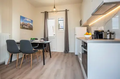 a kitchen and dining room with a table and chairs at Beautiful loft close to Acropolis in Athens