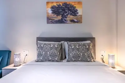 a bedroom with a bed and a painting on the wall at Beautiful loft close to Acropolis in Athens