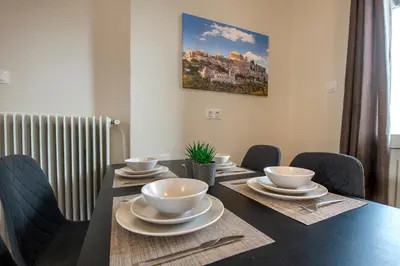 a dining room table with bowls and plates on it at Beautiful loft close to Acropolis in Athens