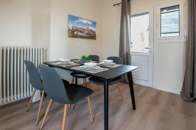 a black dining room table and chairs in a room at Beautiful loft close to Acropolis in Athens