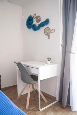 a white desk with a chair in a bedroom at Naiads Nest - The Blue Wave in Varkiza