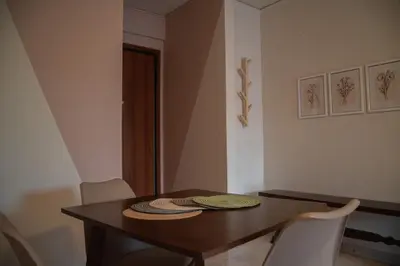 a dining room with a wooden table and chairs at Naiads Nest - The Cozy Retreat in Varkiza