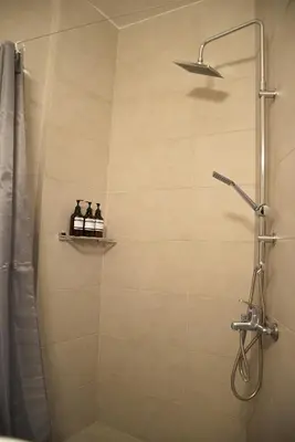 a bathroom with a shower with a shower curtain at Naiads Nest - The Cozy Retreat in Varkiza